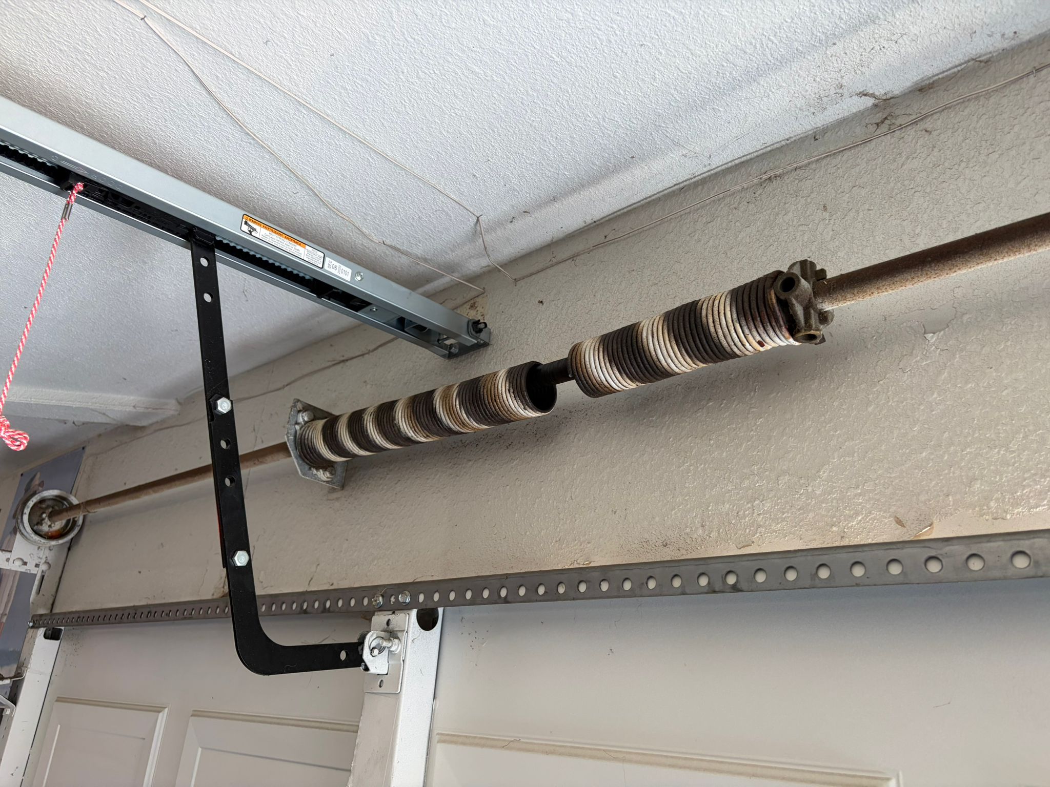 Completely unwound broken garage door spring